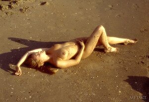 Superb blonde with a fit body decides to go topless on the beach
