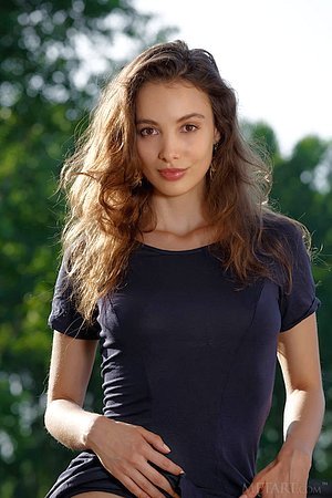 Young Latina with a winning smile seduces the viewer with her body