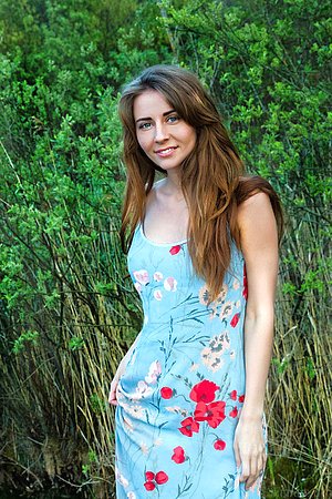 Buxom young brunette happily shows off both indoors and outdoors