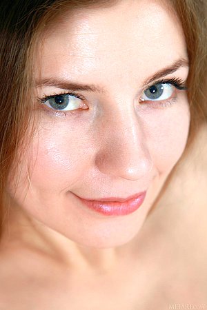 Black bodysuit brunette shows her peachy pussy on a cozy armchair
