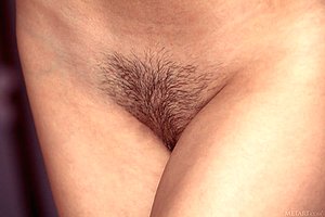 Baby-faced brunette with a small-looking bod shows her trimmed pussy