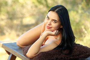 Raven-haired chick with a perfect body humping a pillow on a picnic table