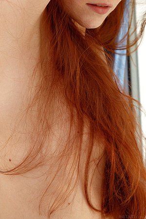 Tanned redhead in a see-through get-up shows off her pussy for you
