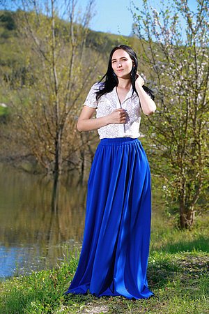 Pale-skinned brunette takes off her long, LONG skirt to show her pussy