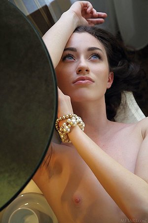 Blue-eyed and wavy-haired brunette showing off her long legs