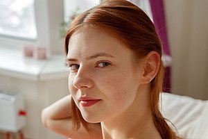 Redhead dressed in red shows her immaculate labia up close on cam