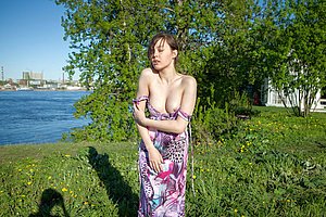 Dress-wearing brunette showing her hairy labia on a luxurious sofa