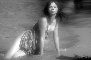 B&W pictures showing a dark-haired 18-year-old naturist posing on a beach