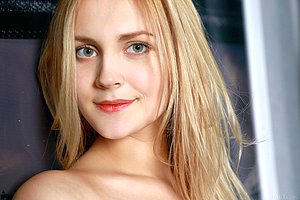 Blue-eyed and beautiful-looking blonde spreads her slender legs