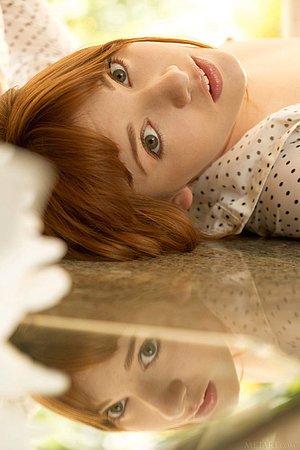 Redhead in see-through black panties enjoys her morning coffee naked